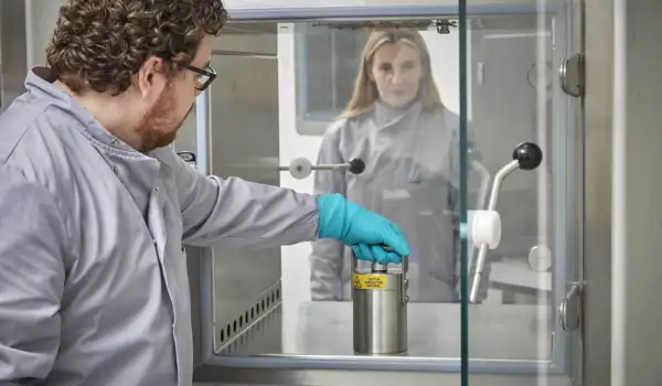 Dr Dave Roberts posting a dose through to Sallyann Wright, ready for release to patients